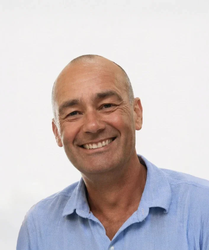 Man wearing a light blue shirt against a white background